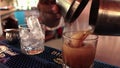 Bartender serving a carajillo coffee alchoholic drink in bar