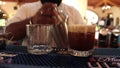 Bartender serving a carajillo coffee alchoholic drink in bar