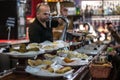 Bartender serving pintxo or tapas on the counter of a bar in the city of Bilbao