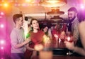 Bartender shaking cocktail for friends in nightclub Royalty Free Stock Photo