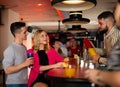 Bartender shaking cocktail for friends in nightclub Royalty Free Stock Photo