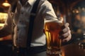 A bartender shows off a freshly poured beer