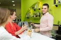 Bartender and smiling women at bar Royalty Free Stock Photo