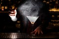 Bartender spraying with aroma essence to a Dirty Martini cocktail