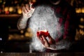 Bartender spraying on the Sazerac cocktail with orange zest Royalty Free Stock Photo