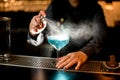 Bartender sprinkles on blue cocktail in glass on bar Royalty Free Stock Photo