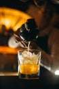 The bartender squeezes citrus juice into a cocktail. Royalty Free Stock Photo