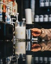 Bartender stands behind a bar at a restaurant, serving a refreshing beverage Royalty Free Stock Photo