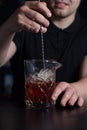 Bartender stirring alcoholic cocktail in a measuring glass Royalty Free Stock Photo