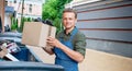 Bartender is throwing Away big paper box. man with paper box in hand near of trash container Royalty Free Stock Photo