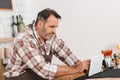 mature happy bartender using tablet