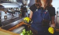 Bartender wearing medical latex black gloves, hold lemons. Process of bartending in bar