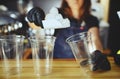 Bartender wearing medical latex black gloves, making mojito cocktail.Pieces of ice,ingredient for cooling drinks in bar