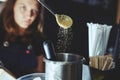 Process of bartending in bar,pouring a tablespoon of brown sugar in shaker