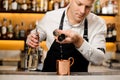 Bartender pouring a portion of alcoholic drink into the cup Royalty Free Stock Photo