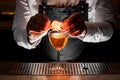 Bartender making the fresh alcoholic drink with a smoky note