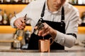 Bartender in white shirt pouring a portion of alcoholic drink in Royalty Free Stock Photo