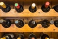 Bartender at wine cellar full of bottles with exquisite drinks Royalty Free Stock Photo