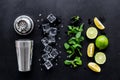 Bartender work desk with equipment and cocktail ingredietns Shaker, lime, ice on black background top-down