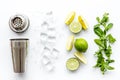 Bartender work desk with equipment and cocktail ingredietns Shaker, lime, ice on white background top-down Royalty Free Stock Photo