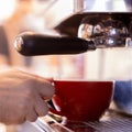 Bartender working on coffee machine in red cup Royalty Free Stock Photo