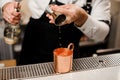 Bartenders hand pouring a portion of alcoholic drink into the cup Royalty Free Stock Photo