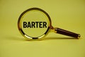 Barter text with magnifying glass on yellow background Royalty Free Stock Photo