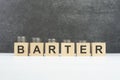 barter word, text written on wooden cubes on a black background with coins on cubes Royalty Free Stock Photo