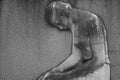 Bas relief sculpture of a grieving woman on a grave