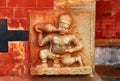 Bas-relief Demon who drinks milk. The ancient image on the wall. India