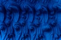 A bas-relief element in the form of sea waves at the base of the Buddha statue in a Buddhist temple. Abstract Indigo Royalty Free Stock Photo