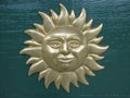 The bas-relief Face of the Sun is hinging on the door Royalty Free Stock Photo