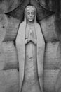 Bas relief sculpture of mother Mary on a grave. Historic graveyard. Royalty Free Stock Photo