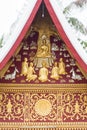 Bas-relief on the wall of the temple Wat Sensoukaram in Louangphabang, Laos. Vertical. Close-up. Royalty Free Stock Photo