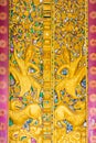 Bas-relief on the wall of the temple Wat Sensoukaram in Louangphabang, Laos. Vertical. Close-up. Royalty Free Stock Photo