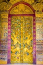 Bas-relief on the wall of the temple Wat Sensoukaram in Louangphabang, Laos. Vertical. Close-up. Royalty Free Stock Photo