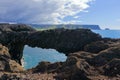 Dyrholaey Basalt Lava Arch above Rugged Coastline near Reynisdrangar Rocks, South Coast of Iceland Royalty Free Stock Photo