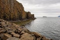 Basalt rocks and Stykkisholmsbaer circuit reflected in waters of an ocean near the city Stykkisholmur, Iceland