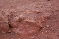 Basaltic rock structure among red volcanic soil Royalty Free Stock Photo