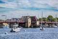 Spa creek drawbridge in Annapolis, Maryland with a cabin cruiser boat and sailboats in the foreground..