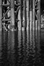 The base of the bridge is reflected in the water, the black and white photo Royalty Free Stock Photo