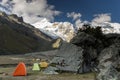 Base camp in the Cordillera Blanca with snow-capped mountains and large boulders