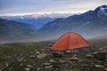 Base camp set in Alpine background. Ten set on hill i Alps mountains. Tourist shelter camp in high mountains