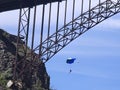 Base jumper parachutes by bridge Royalty Free Stock Photo