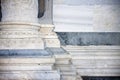 Base of the marble columns with white stone frame of a romanesque Italian church