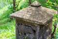 Base vintage stone old lamp in the garden of the tradition of Asia carved figures of animal elephants with a triangular roof