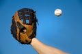 Baseball in air about to be caught by glove. Royalty Free Stock Photo