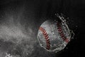 Baseball ball flying in water drops and splashes isolated on black background Royalty Free Stock Photo