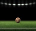 Baseball ball on a grass field with stripe and black background under lights Royalty Free Stock Photo