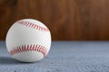 Baseball ball on grey wooden table, closeup. Space for text Royalty Free Stock Photo